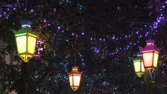 Illuminations du Voyage en hiver à Nantes avec des lanternes colorées suspendues dans un arbre.